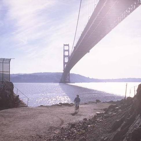 Kim on bicycle under GG Bridge in 1990