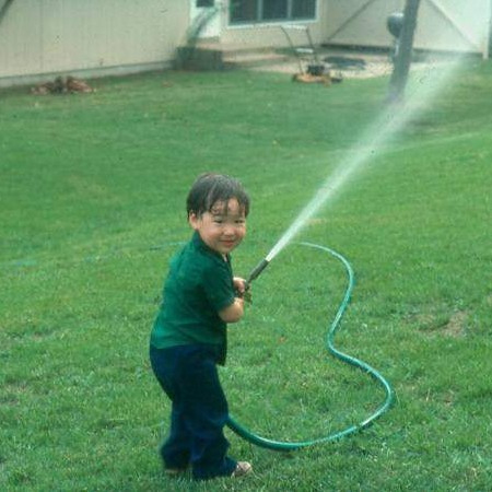 Zachary with hose in FLW backyard ~ summer 1977