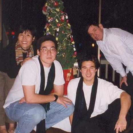 Family around Christmas tree in 1997