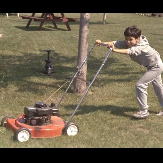 Simon cutting Grass in Tomah in 1987
